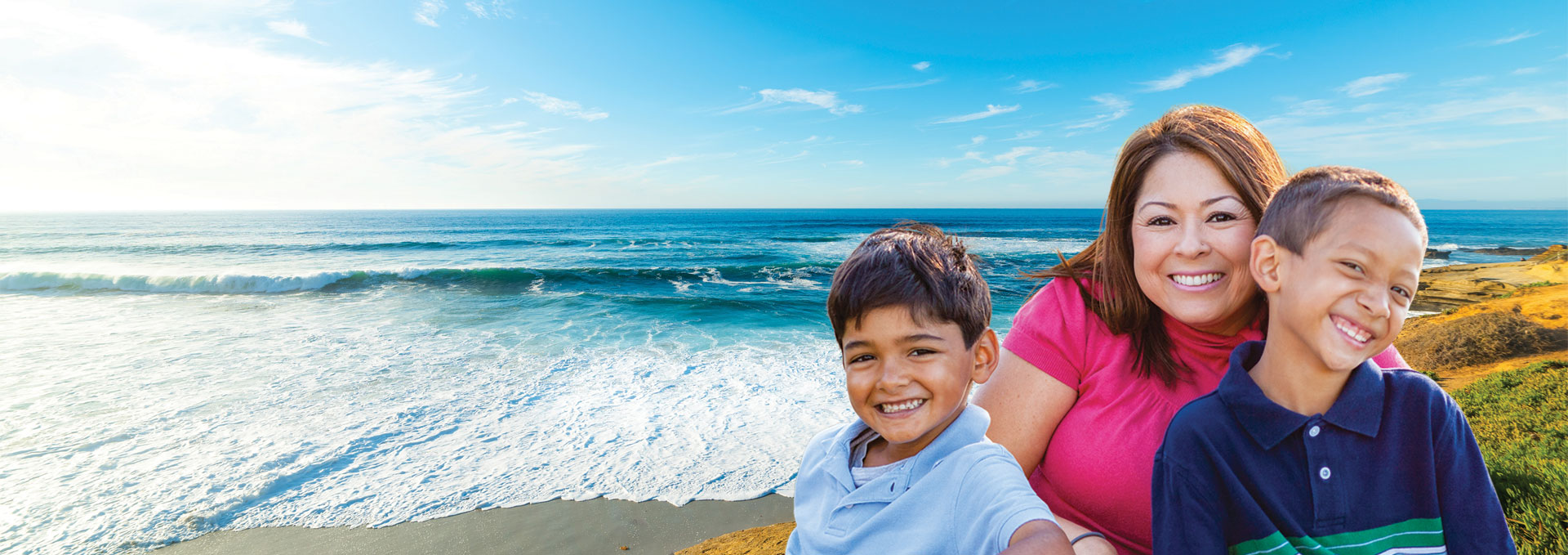 Mother and two sons by the coast.